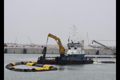 Pipelines transfer dredged sand ashore from APM’s barge and feeder quays. Photo: Peter Barker